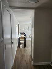 Corridor with dark wood-style floors and baseboards