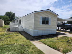 View of side of property with a yard