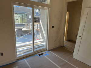 Doorway to outside with baseboards