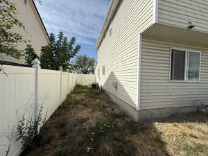 View of side of home featuring a central air condition unit
