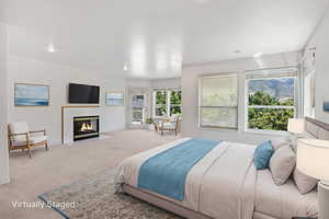 Carpeted bedroom with a tile fireplace, access to outside, and recessed lighting