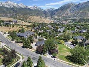 Aerial view of property's location with a mountainous background and nearby suburban area