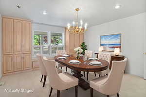 Dining space featuring a chandelier, recessed lighting, and light carpet