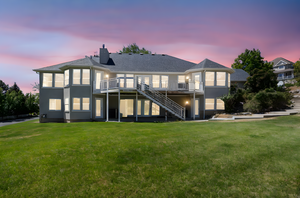 Back of property featuring stairs, a patio area, a yard, and a deck