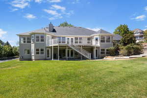 Rear view of property featuring a patio, stairway, a yard, a chimney, and a wooden deck