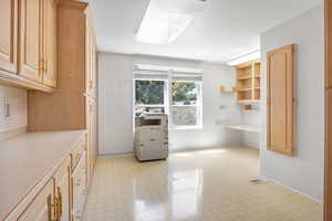 Unfurnished dining area featuring light flooring and baseboards