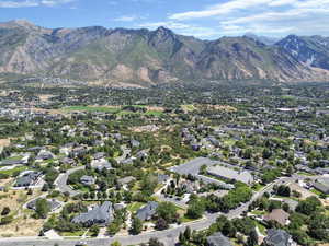 View of property location with mountains and nearby suburban area