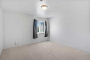 Carpeted spare room with baseboards