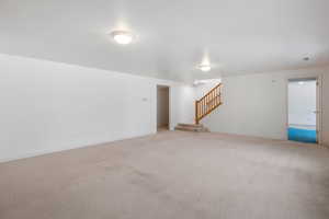 Below grade area featuring carpet and stairway