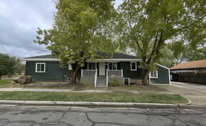 View of front of property with a porch and a shingled roof