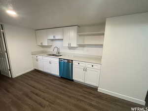 Kitchen featuring white cabinets, open shelves, dishwasher, and dark wood-style flooring