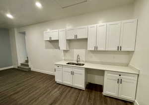 Kitchen featuring white cabinetry and dark wood-style flooring