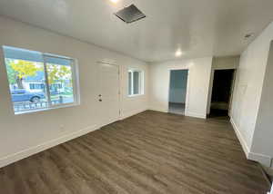 Entrance foyer with a textured ceiling and dark wood-style flooring
