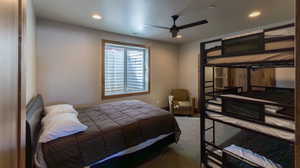 Carpeted bedroom featuring a ceiling fan and recessed lighting