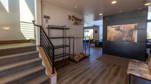Staircase featuring wood finished floors and recessed lighting