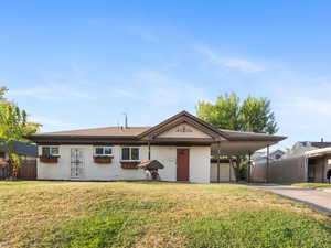 Single story home featuring driveway and an attached carport