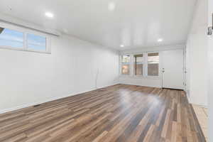 Unfurnished room featuring wood finished floors and recessed lighting