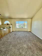 Spare room featuring carpet and plenty of natural light