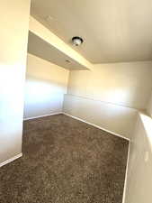 Carpeted empty room featuring baseboards