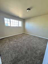Unfurnished room with carpet and baseboards