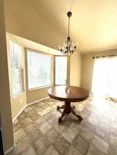 Dining room featuring lofted ceiling and a chandelier