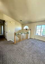 Spare room featuring carpet and baseboards