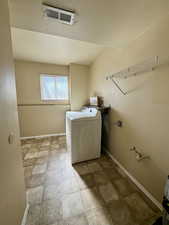 Laundry room featuring stone finish flooring and electric dryer hookup