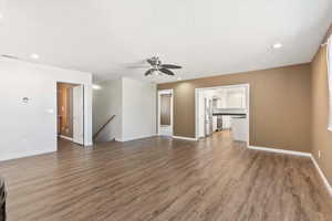 Large living room with plenty of space, with a bright kitchen straight ahead.