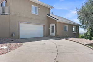 View of side of home featuring entrances and two car garage