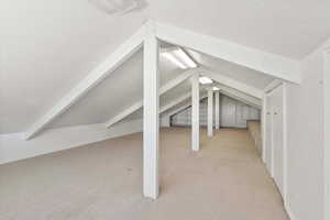 Finished attic with venting and carpet. Great for a play room or hangout space
