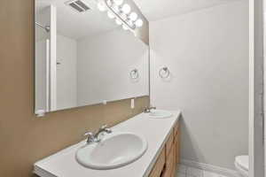 Full bathroom with double vanity and shower and tub combo