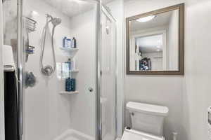 3/4 bathroom featuring a newer shower stall