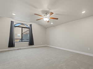 Empty room with light colored carpet, recessed lighting, a textured ceiling, a ceiling fan, and vaulted ceiling
