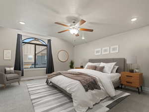 Bedroom featuring recessed lighting, light carpet, a ceiling fan, and a textured ceiling