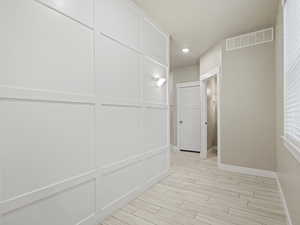 Hallway featuring wood tiled floors and recessed lighting