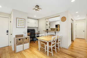 Dining space featuring light wood-style flooring, recessed lighting, and built in desk