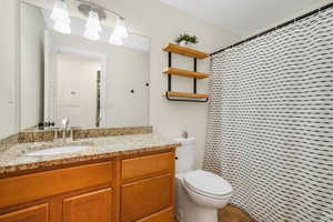 Full bath featuring vanity, curtained shower, a chandelier, and tile patterned floors