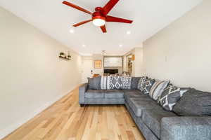 Living area with light wood-style floors, recessed lighting, and ceiling fan