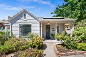 Bungalow-style home featuring covered porch and roof mounted solar panels