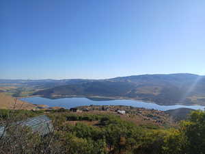 View of mountain backdrop featuring a nearby body of water