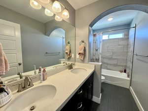 Full bath featuring shower / tub combo and double vanity