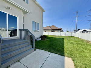 Fenced backyard with a patio area
