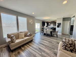 Living room with recessed lighting, dark wood-style floors, and a textured ceiling