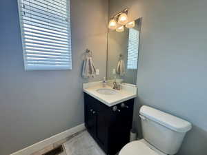 Half bath featuring vanity and light tile patterned flooring