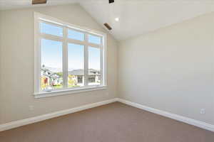 Carpeted spare room with lofted ceiling and recessed lighting