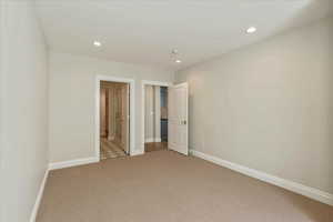Unfurnished bedroom featuring light colored carpet and recessed lighting