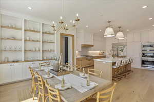 Dining space featuring light wood-style floors, a chandelier, and recessed lighting