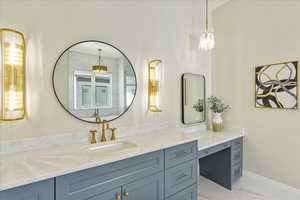 Bathroom with vanity and light marble finish flooring