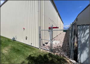 View of outbuilding with a gate