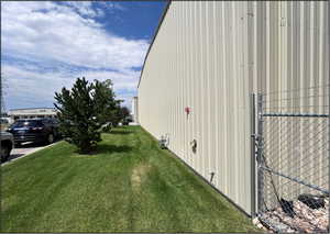 View of side of property with a lawn